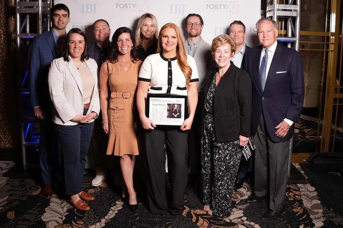 Wealth advisor at IBJ Forty Under 40 award ceremony with team members
