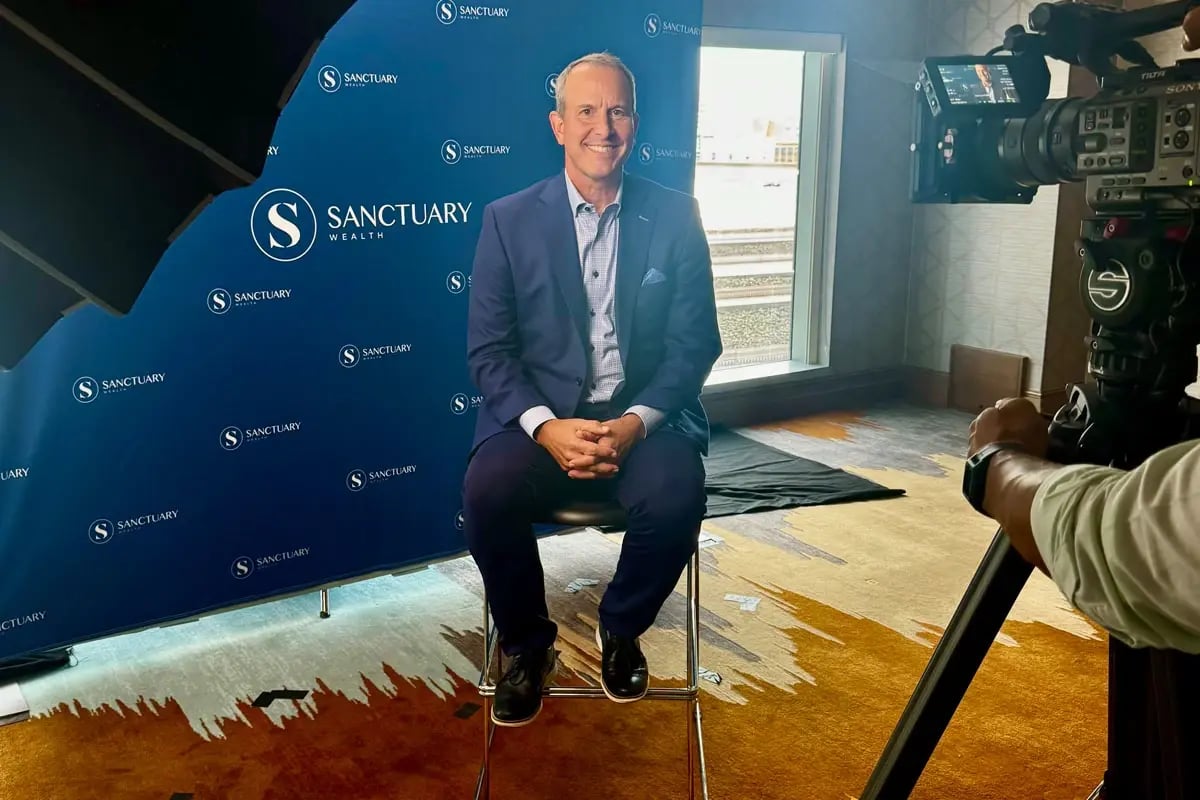 Wealth advisor giving behind the scenes interview at industry event