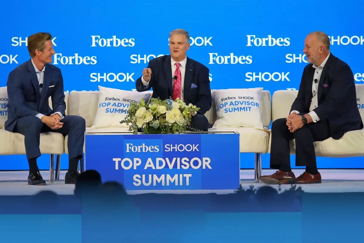 Wealth advisor on stage for panel discussion at industry event