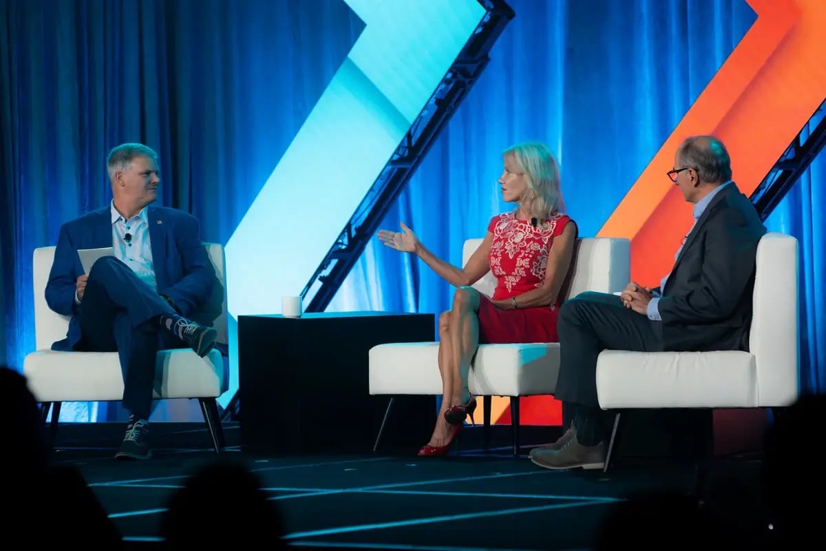 Wealth advisor moderating a panel discussion at an industry event