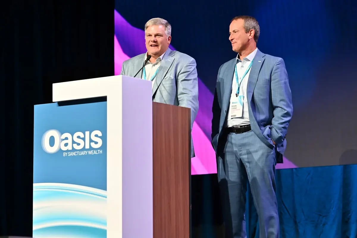 Wealth advisors on stage giving speech at industry event