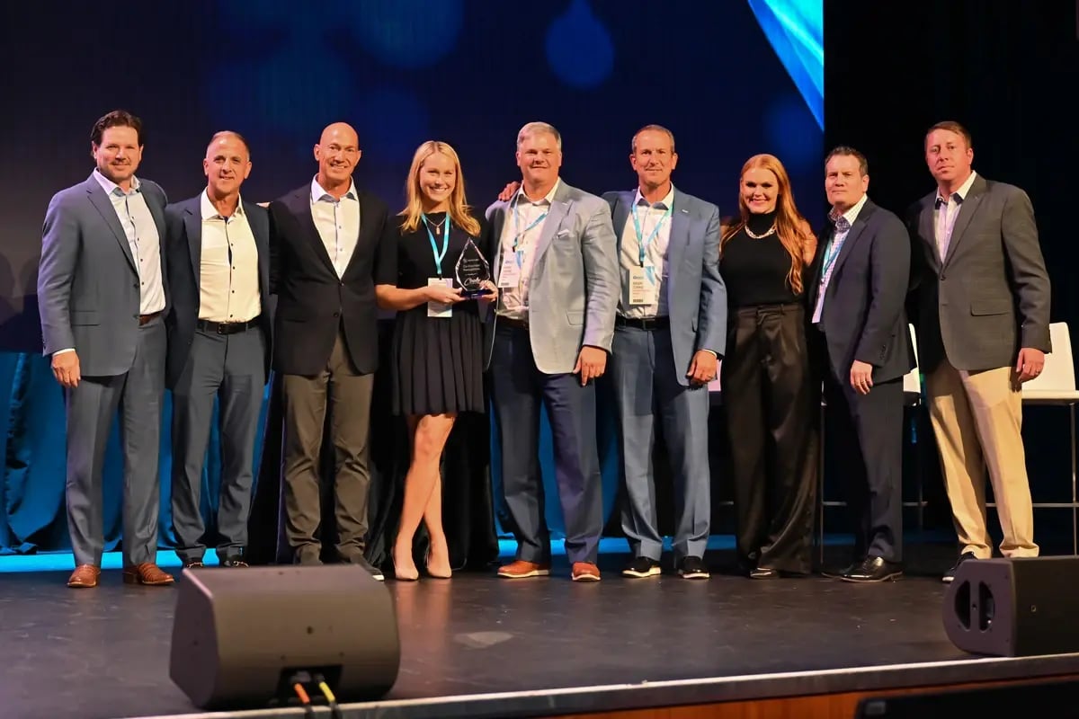 Wealth management team members accepting an award on stage Wealth management team members accepting an award on stage
